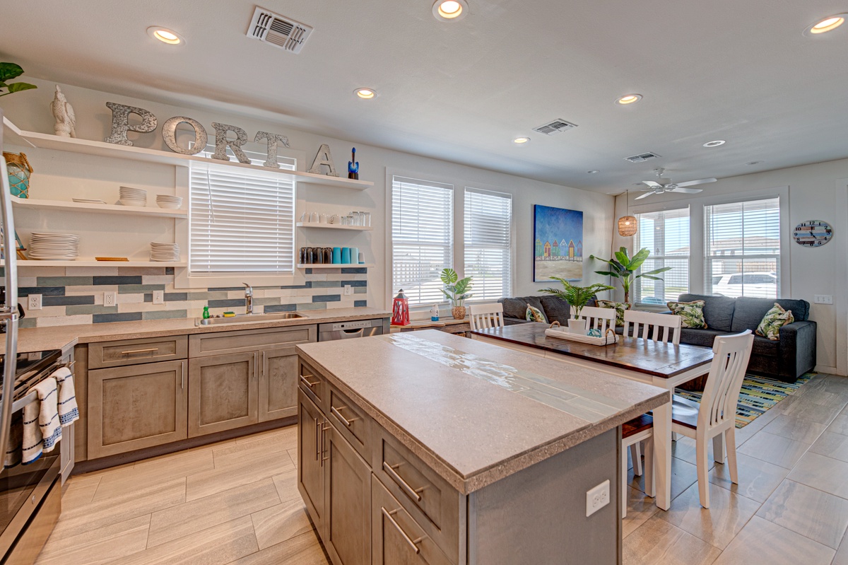 Your spacious kitchen features a large island perfect for cooking and gathering, with modern appliances and bright natural light streaming in.