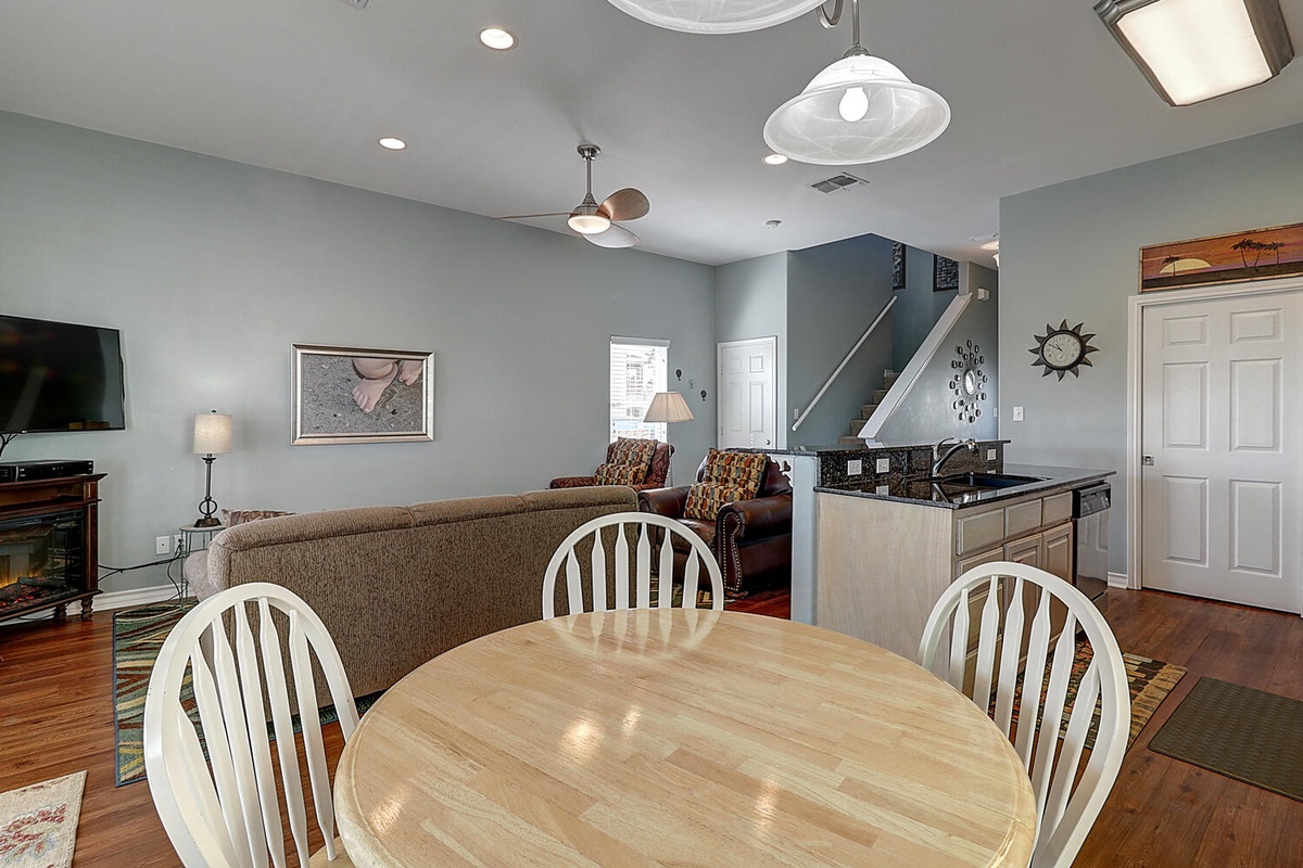 Relax in your open-concept living space featuring a comfortable living room and dining area, perfect for gathering.