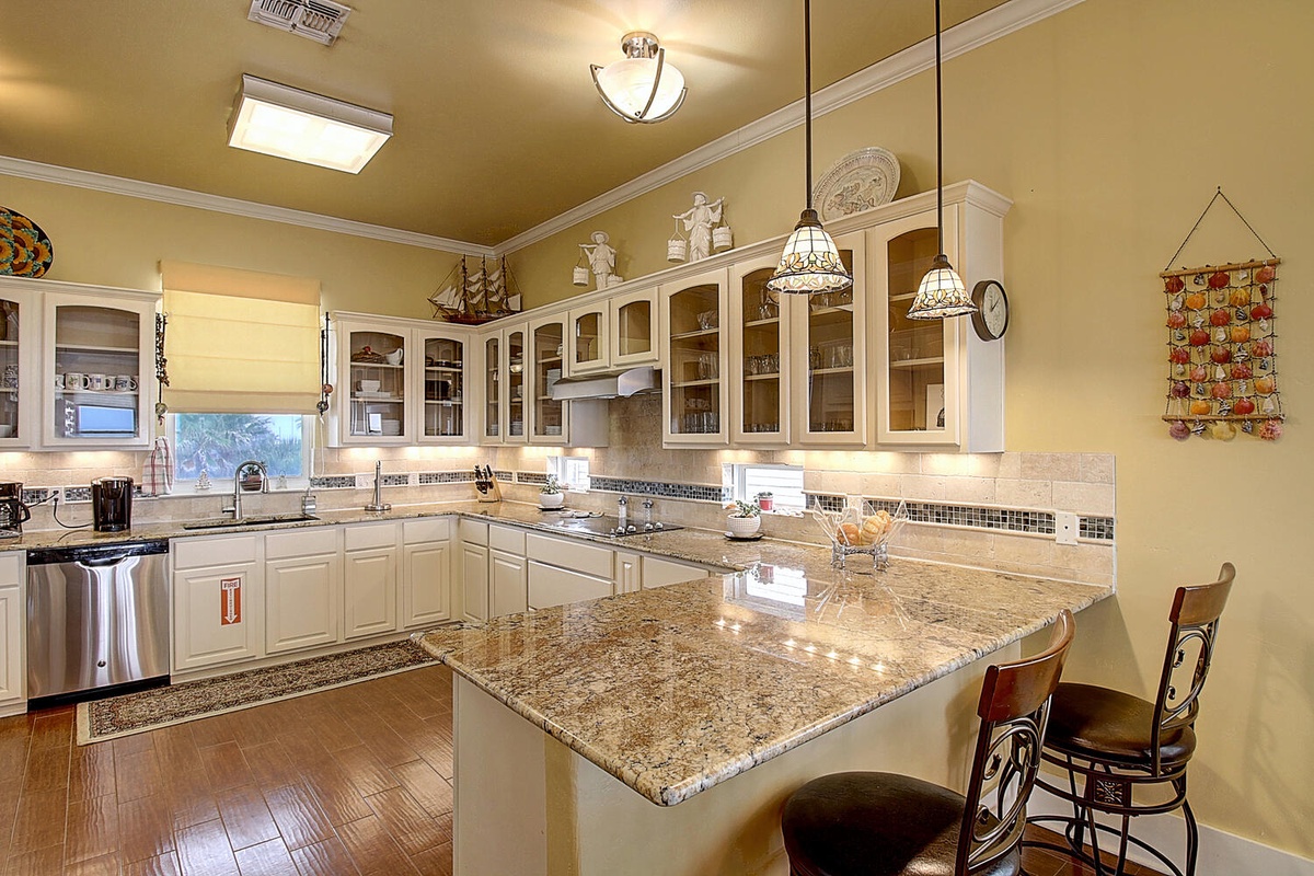 Your culinary adventures await in this spacious gourmet kitchen with granite countertops, premium appliances, and elegant pendant lighting for memorable meal prep.