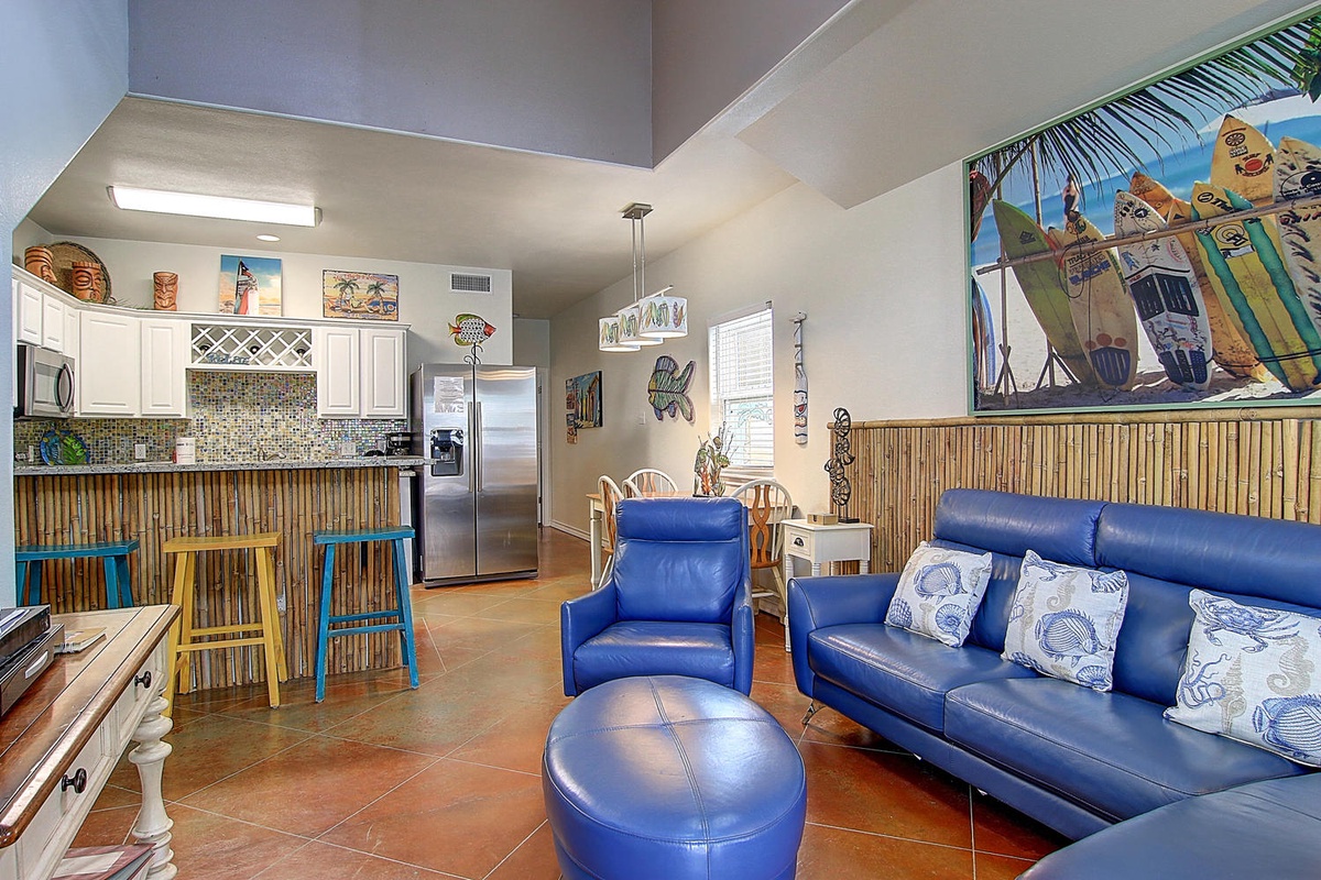 Unwind in your tropical-themed living space where bamboo accents and surf-inspired art create the perfect beach vibe for relaxing.