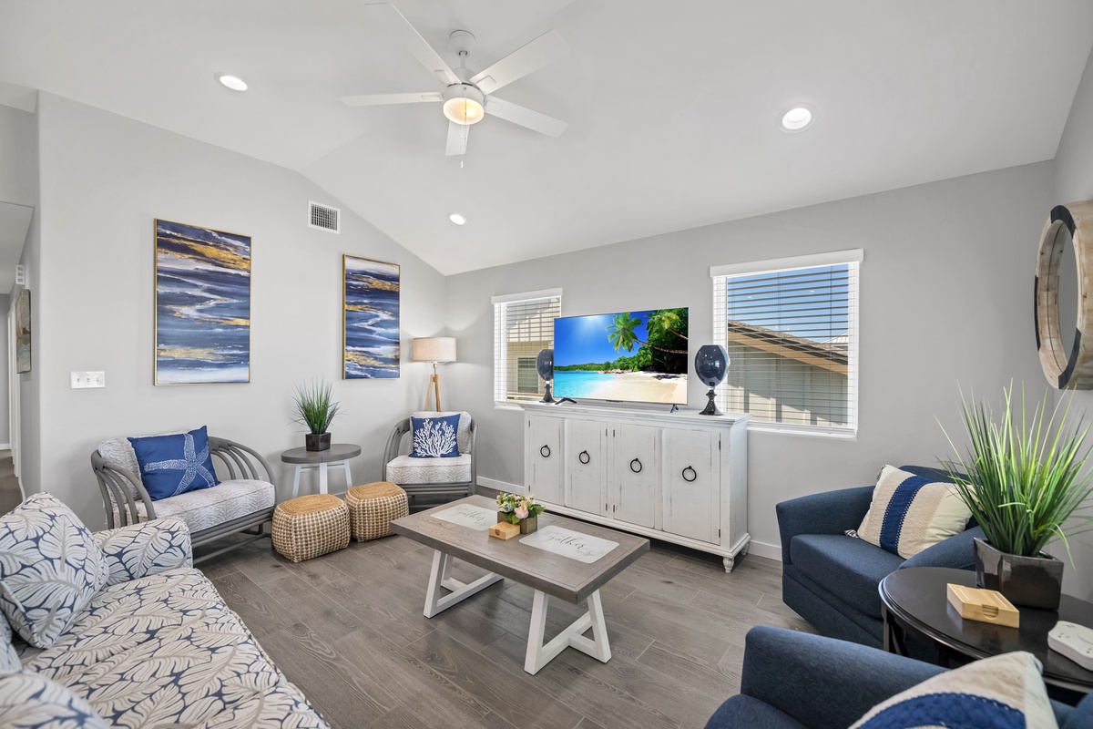 Relax in your stylish living room with coastal-inspired decor, modern furniture, and entertainment center for cozy evenings together.