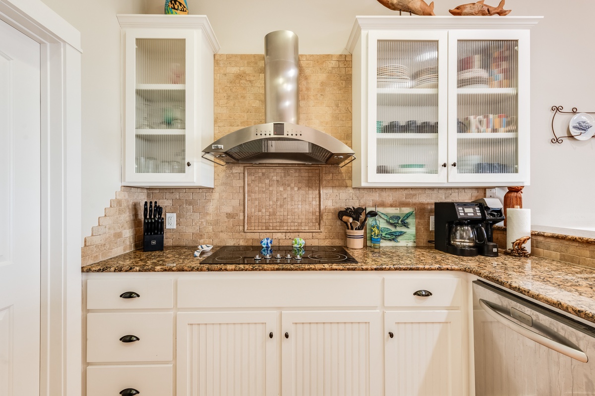 Prepare your favorite meals in this elegantly appointed kitchen featuring granite countertops, stainless steel appliances, and thoughtful coastal touches throughout.