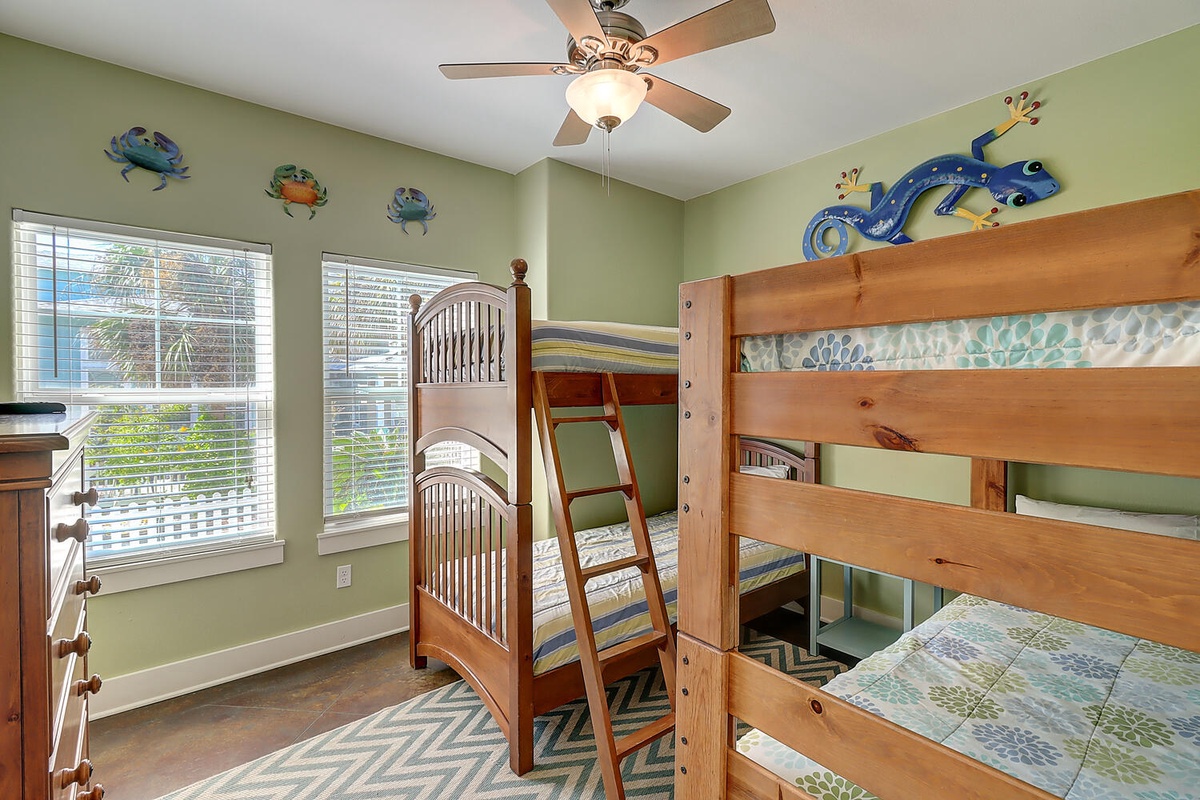 Your kids will love this playful bunk room with cheerful ocean-themed décor, complete with ceiling fan for comfort and sunny windows for natural light.