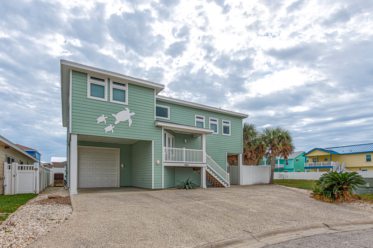 Charming coastal retreat with tropical palm trees and colorful neighborhood homes creating the perfect beach getaway atmosphere.