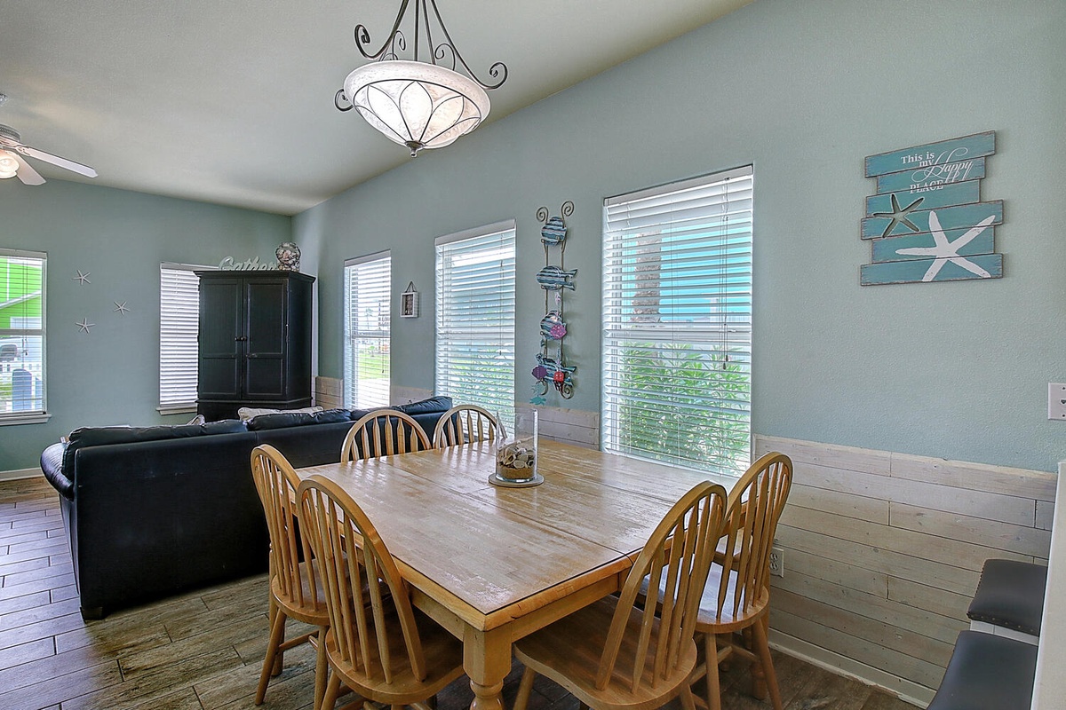 Gather around the spacious dining table where coastal charm meets comfort, perfect for your morning coffee or evening meals together.