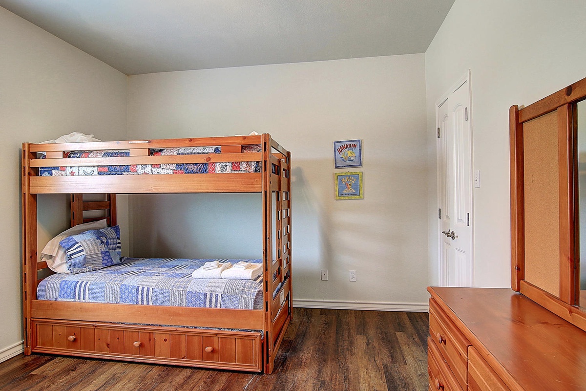 Your kids will love this cozy bunk room with built-in storage and cheerful blue bedding, perfect for creating vacation memories together.