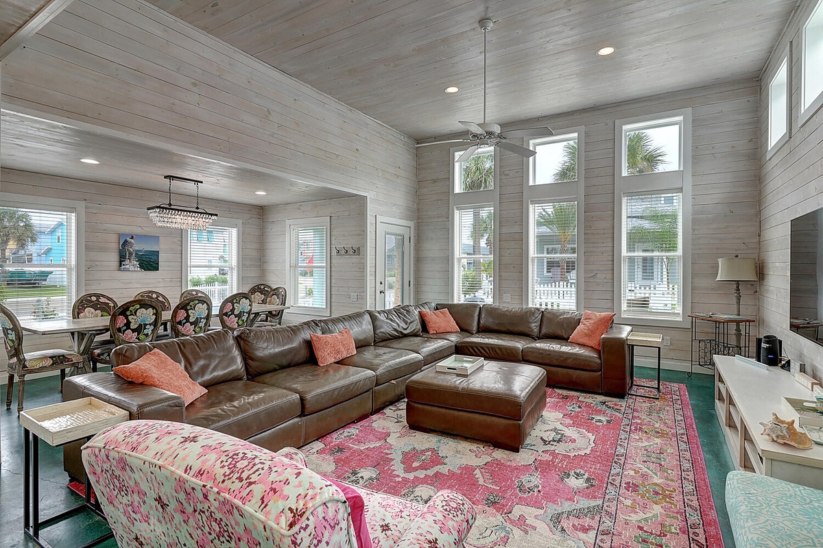 Sink into luxurious leather seating in this bright, airy living space where coastal charm meets comfort—your perfect gathering spot.