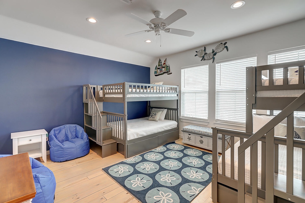 Your kids will love this nautical-themed bedroom with bunk beds, cozy bean bags, and cheerful blue décor.