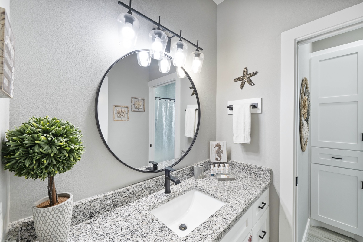 Step into your beautifully appointed bathroom with modern fixtures, elegant granite countertops, and stylish coastal touches that create a spa-like retreat.