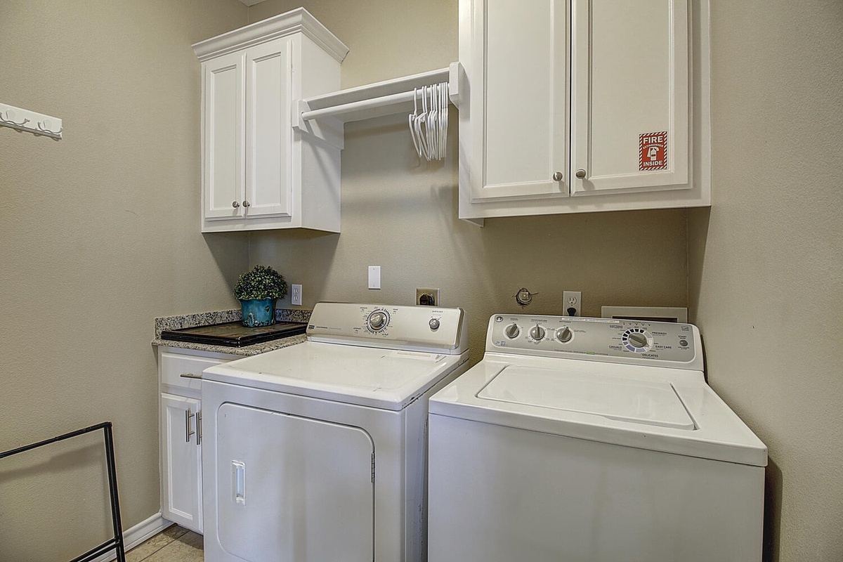 Your private laundry room makes staying fresh effortless with full-size washer and dryer, plus ample cabinet storage for supplies.