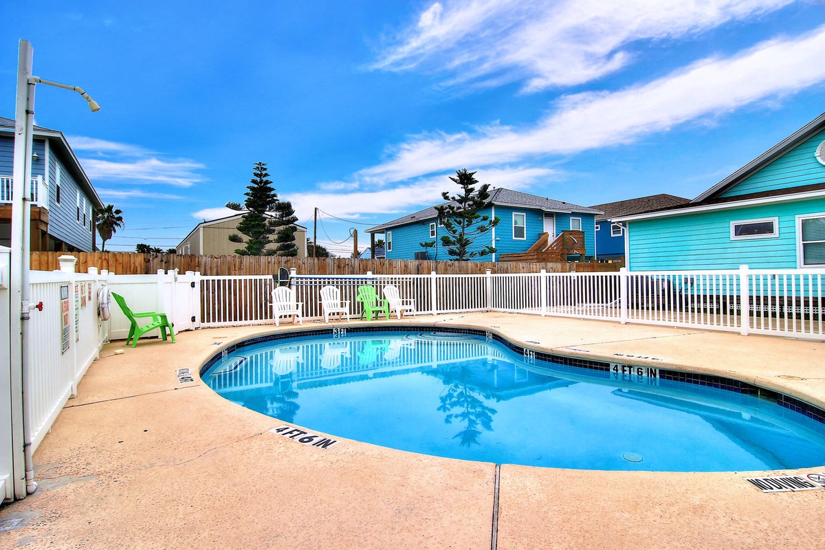 Dive into your own private oasis! This sparkling pool beckons you to cool off under endless blue skies, surrounded by colorful coastal charm.