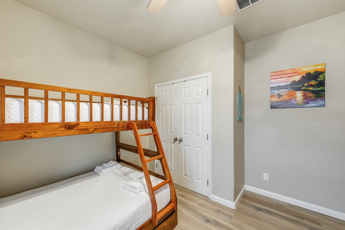 Your kids will love this cheerful bunk bed room with coastal artwork and fresh linens ready for adventure-filled nights.