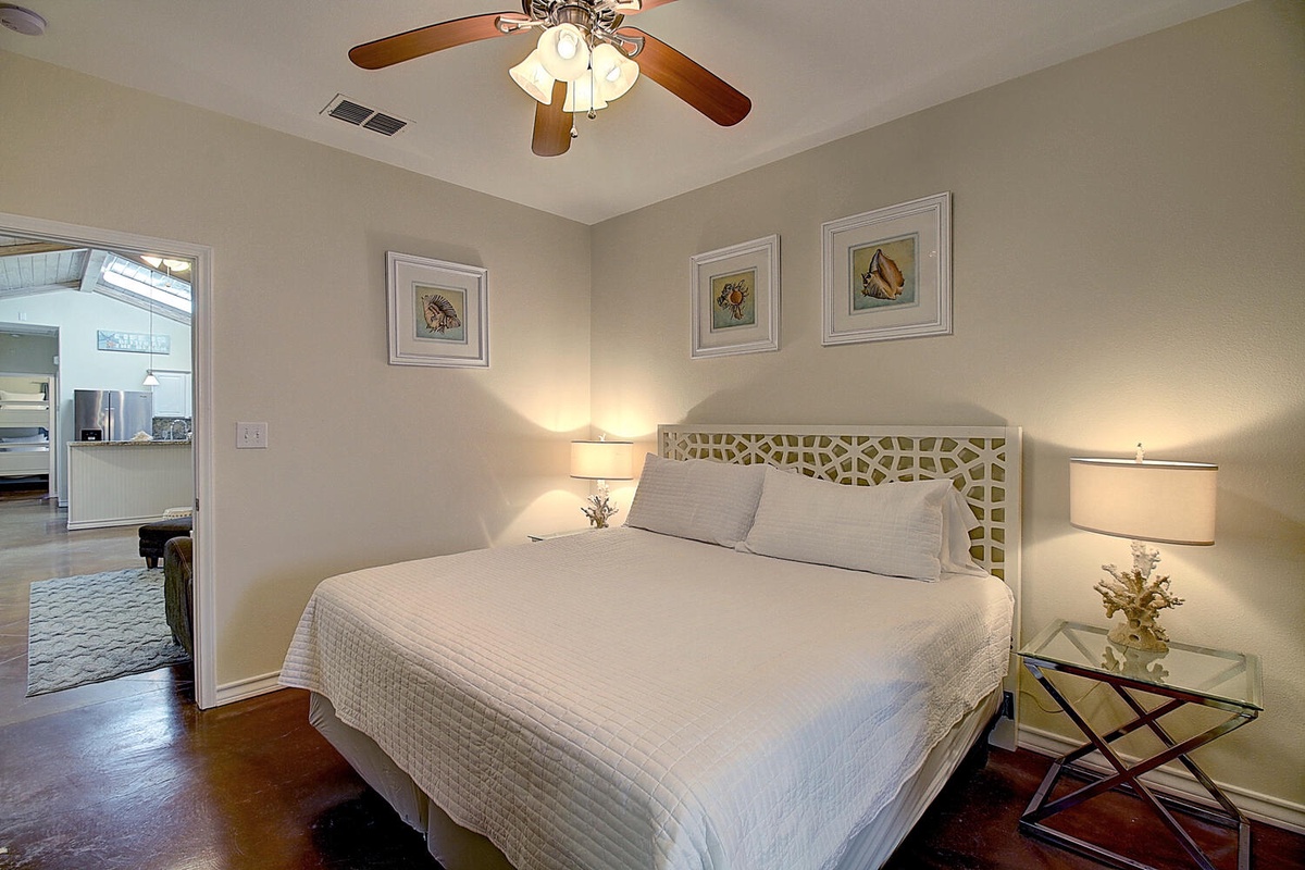 Unwind in your elegant bedroom with crisp linens and gentle ceiling fan breezes creating the perfect sleep sanctuary.