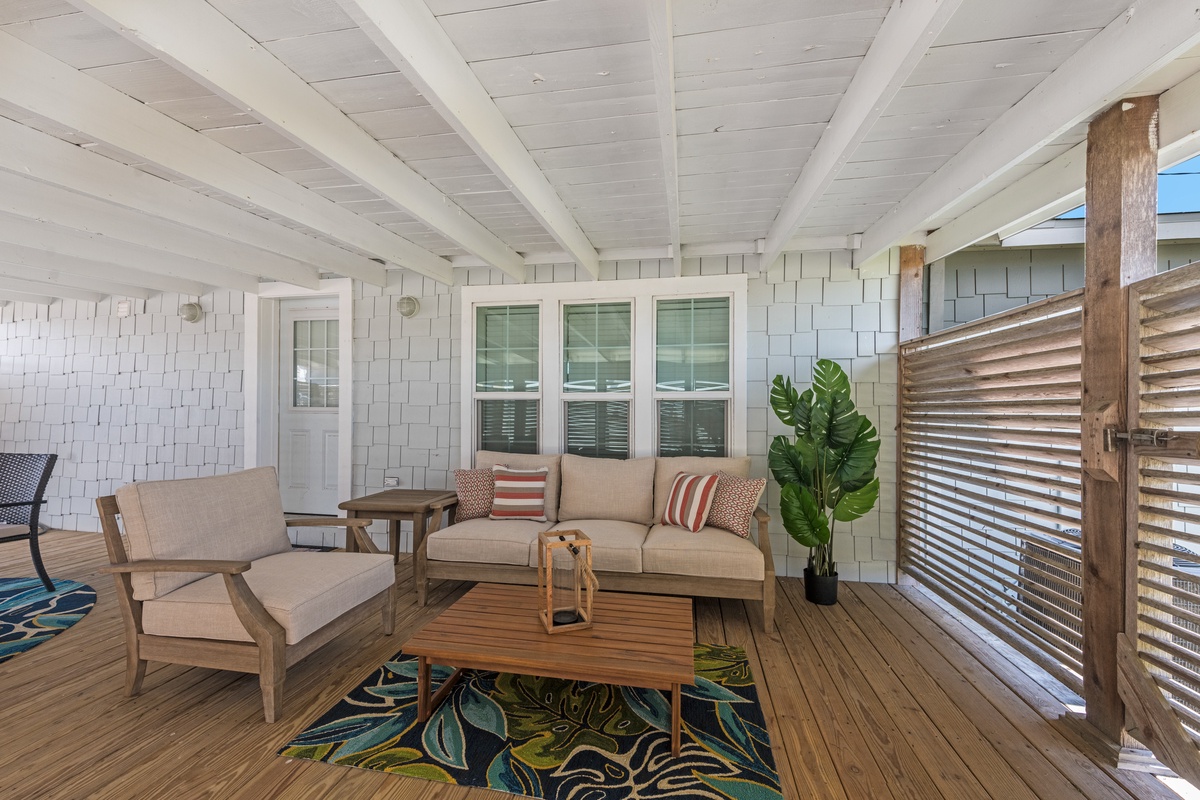 Your covered patio offers cozy comfort with modern coastal style, where you'll love lounging on plush seating surrounded by tropical touches.