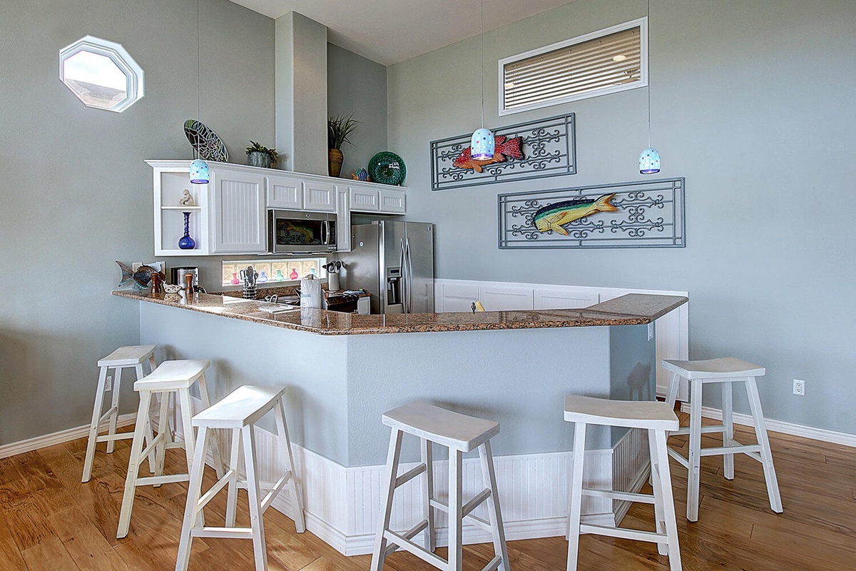 Your fully equipped kitchen features granite counters, stainless appliances, and breakfast bar seating for casual meals and morning coffee.