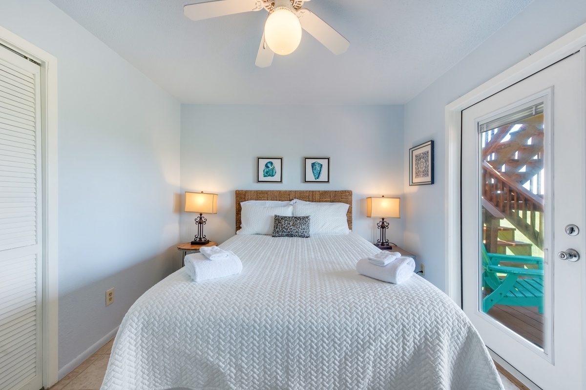 Your peaceful bedroom features crisp linens and soft lighting, creating the perfect coastal retreat for restful nights.