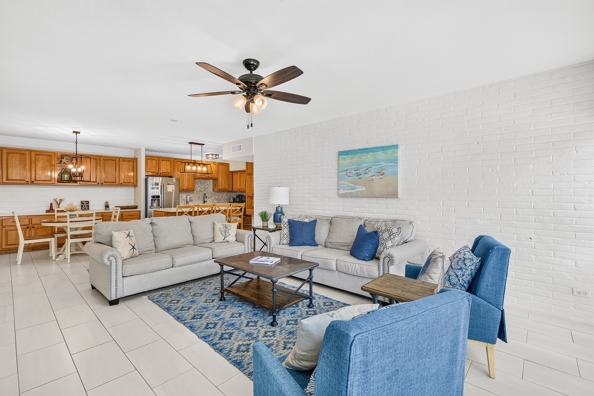 Settle into your coastal-inspired living space with plush seating and stylish accents. The open-concept design flows into a fully equipped kitchen, perfect for gathering with family and friends during your beach getaway.