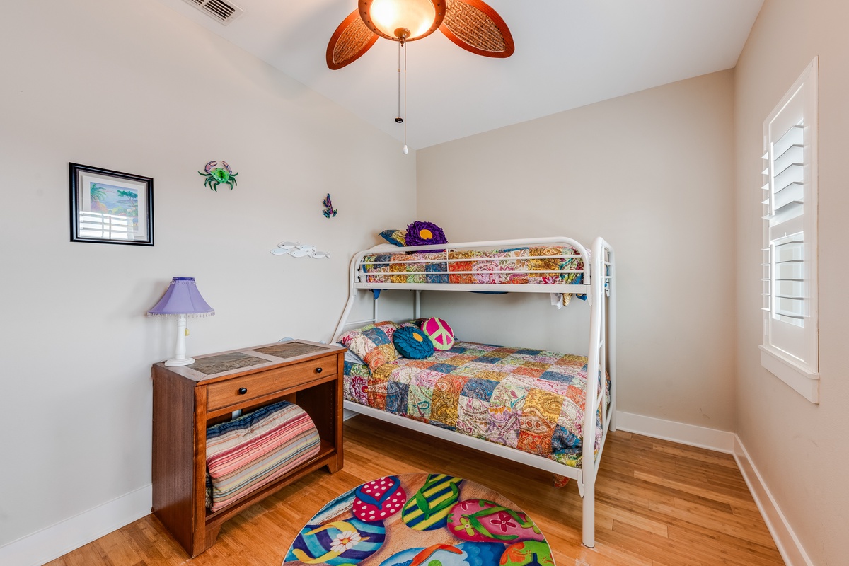 Your kids will love this cheerful bedroom with colorful bunk beds and playful decor creating the perfect space for sweet dreams.