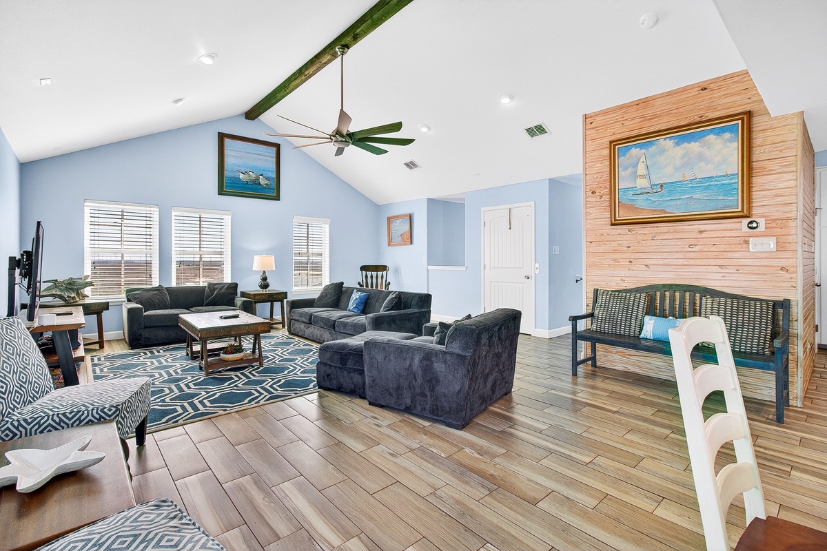 Unwind in your coastal haven with nautical artwork, vaulted ceilings, and plush seating perfect for family gatherings.