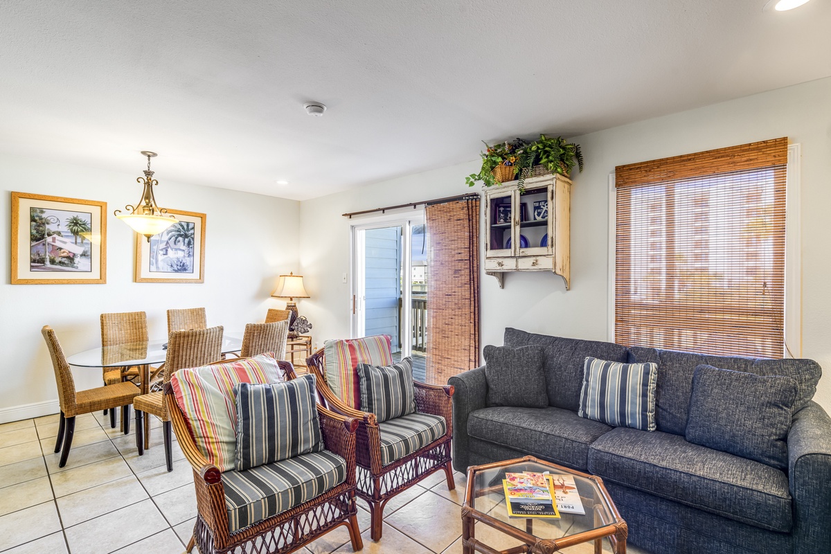 Unwind in your spacious living room where comfortable seating and warm natural light create the perfect retreat after your beach adventures.