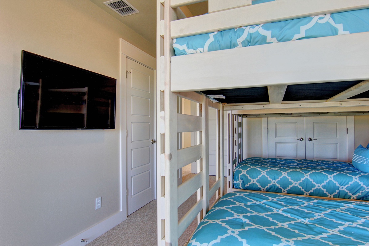 Your group will love these custom bunk beds with cheerful blue bedding, perfect for kids or friends sharing adventures together.