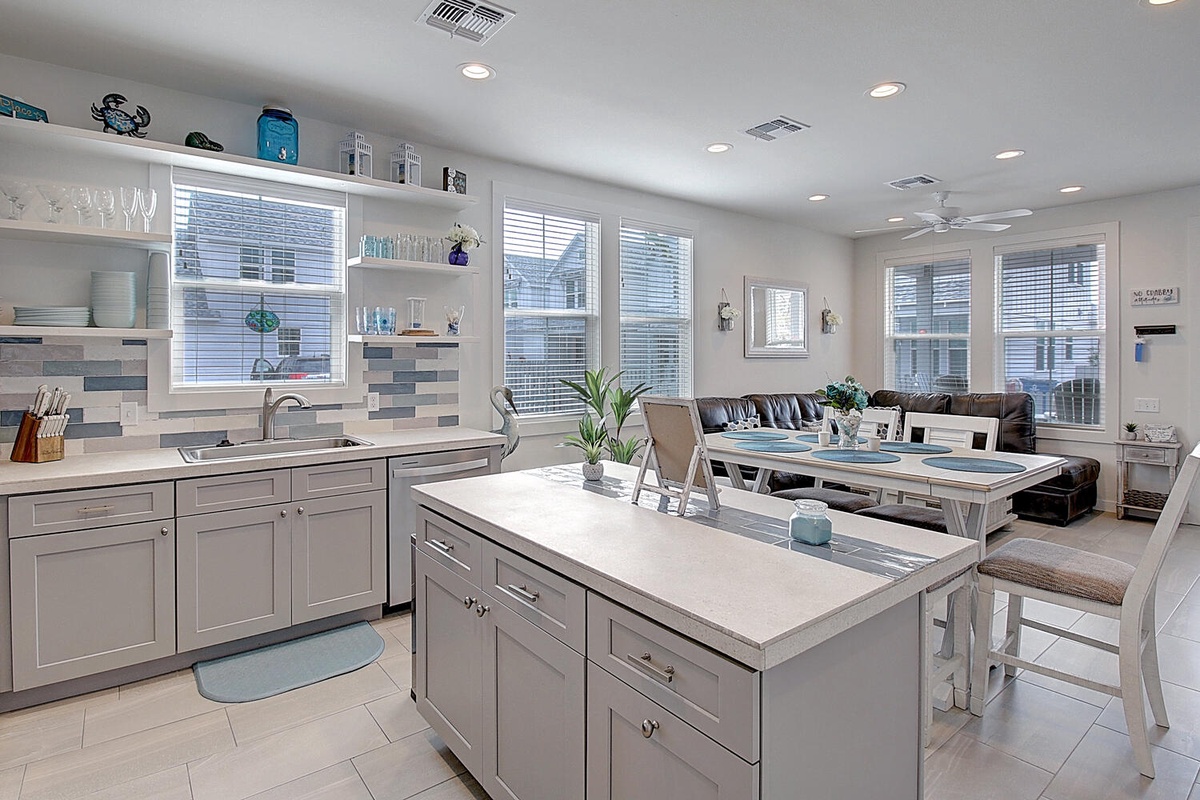Your gourmet kitchen awaits with gleaming countertops, spacious island seating, and seamless flow to the cozy living area.