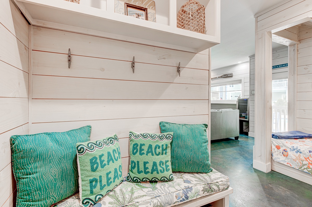 Cozy beach-themed nook with turquoise pillows and nautical charm creates the perfect spot to unwind after coastal adventures.