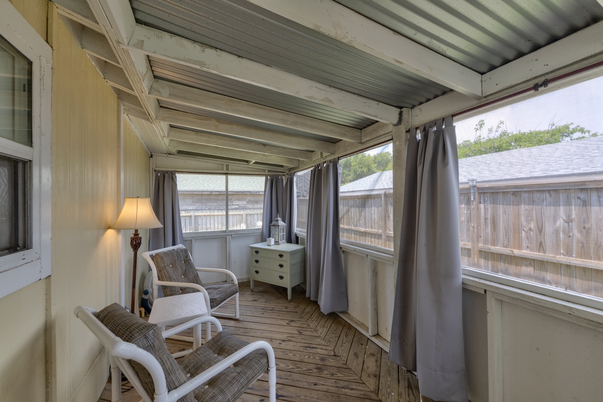 Step into your private screened porch where comfortable seating and soft lighting create the perfect spot to unwind with morning coffee or evening relaxation.