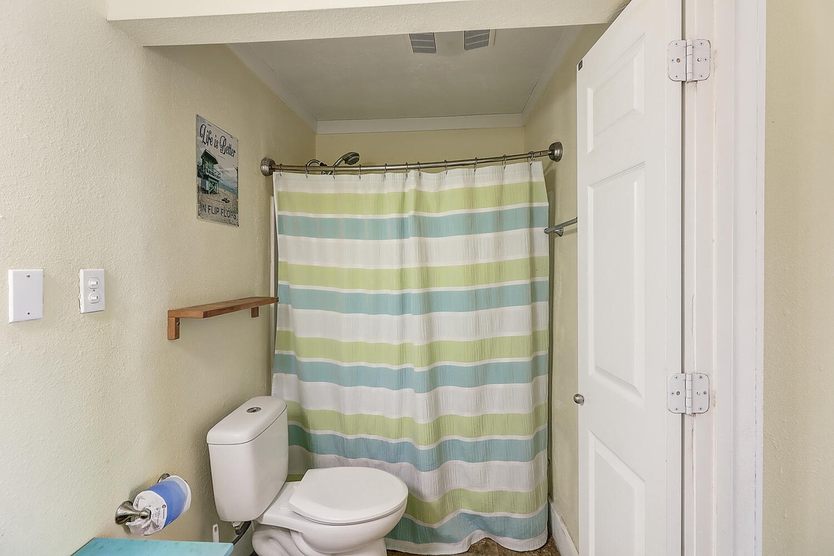 Freshen up in your private bathroom featuring cheerful striped shower curtain and all essentials.