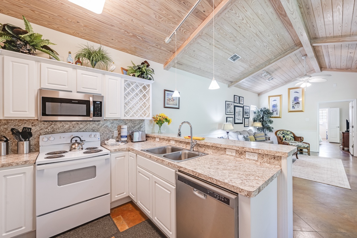 Your fully equipped kitchen features granite countertops, stainless steel appliances, and charming wood-beam ceilings, creating the perfect space to prepare meals.