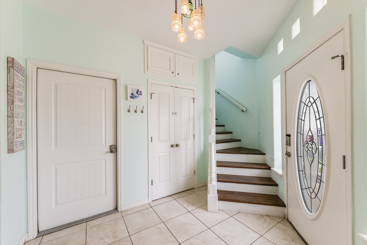 Step into your welcoming entryway with elegant pendant lighting, built-in storage, and charming coastal touches that set the perfect tone for relaxation.