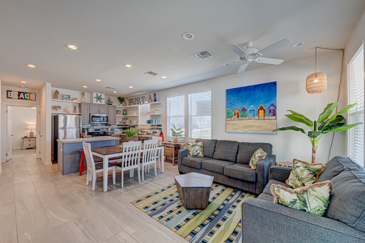 Your coastal haven features an open-concept living space where beach vibes meet comfort—relax on plush sofas while tropical artwork sets the mood.