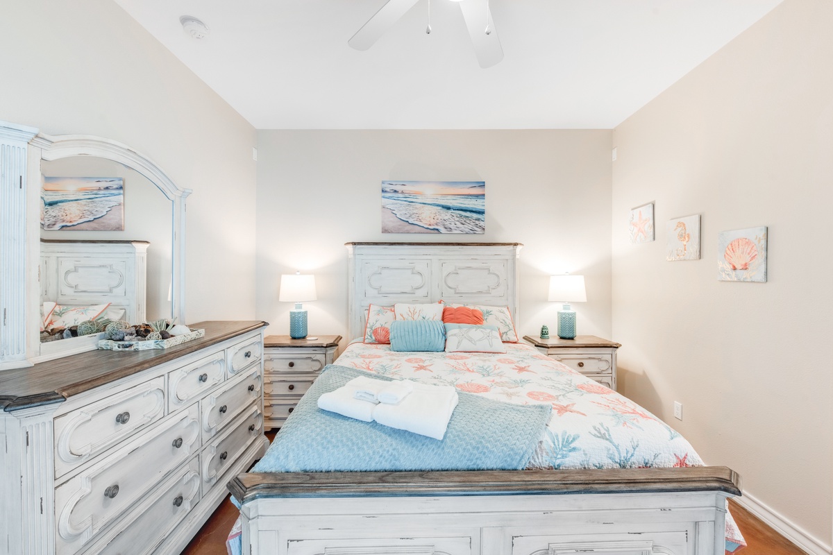 Drift into peaceful dreams in this charming coastal-themed bedroom, where soft ocean hues and beachy artwork create your perfect seaside retreat.