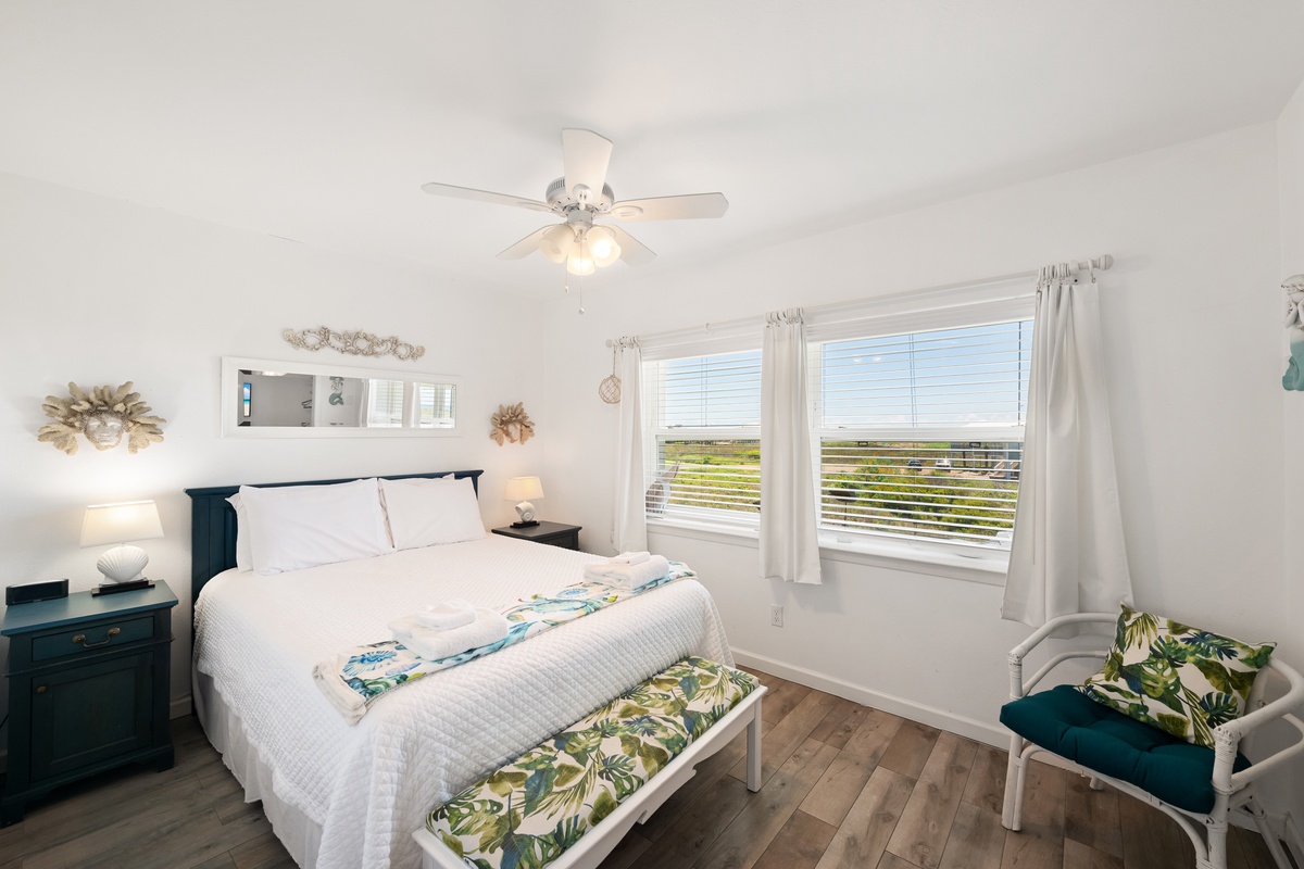 Drift off to peaceful sleep while enjoying views of open green marshlands through your bedroom windows. Fresh white linens and coastal decor create your perfect retreat.