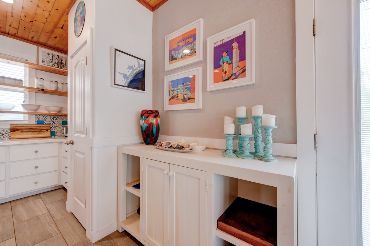 Your bright kitchen features beautiful white cabinetry, warm wood floors, and charming exposed beam ceilings that create a welcoming cooking space.