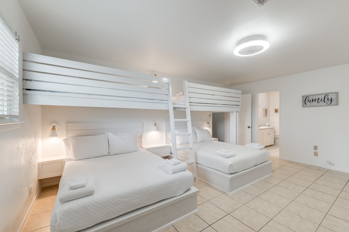 Sleep peacefully in your bright, modern bedroom with custom bunk beds and crisp white linens that promise the perfect family getaway.