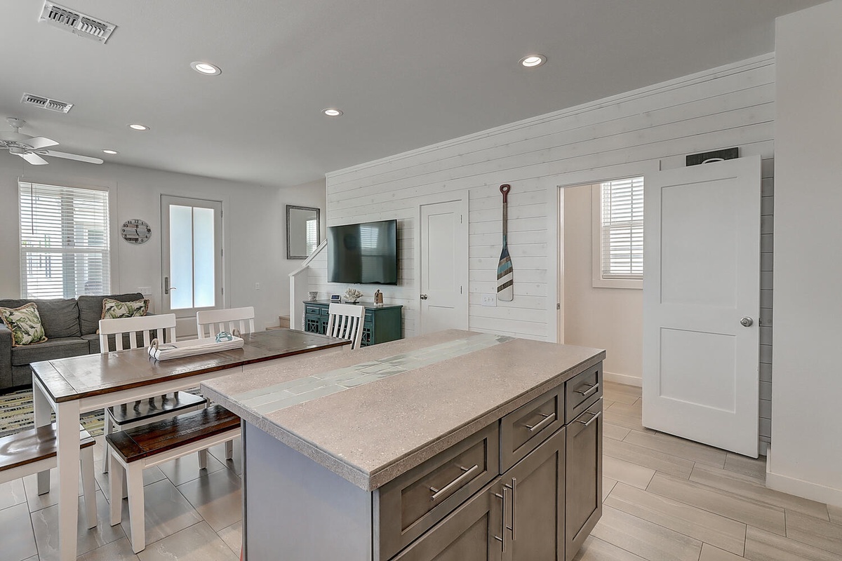 Your spacious kitchen island invites culinary adventures, while the open living area creates perfect gathering space for memorable meals together.