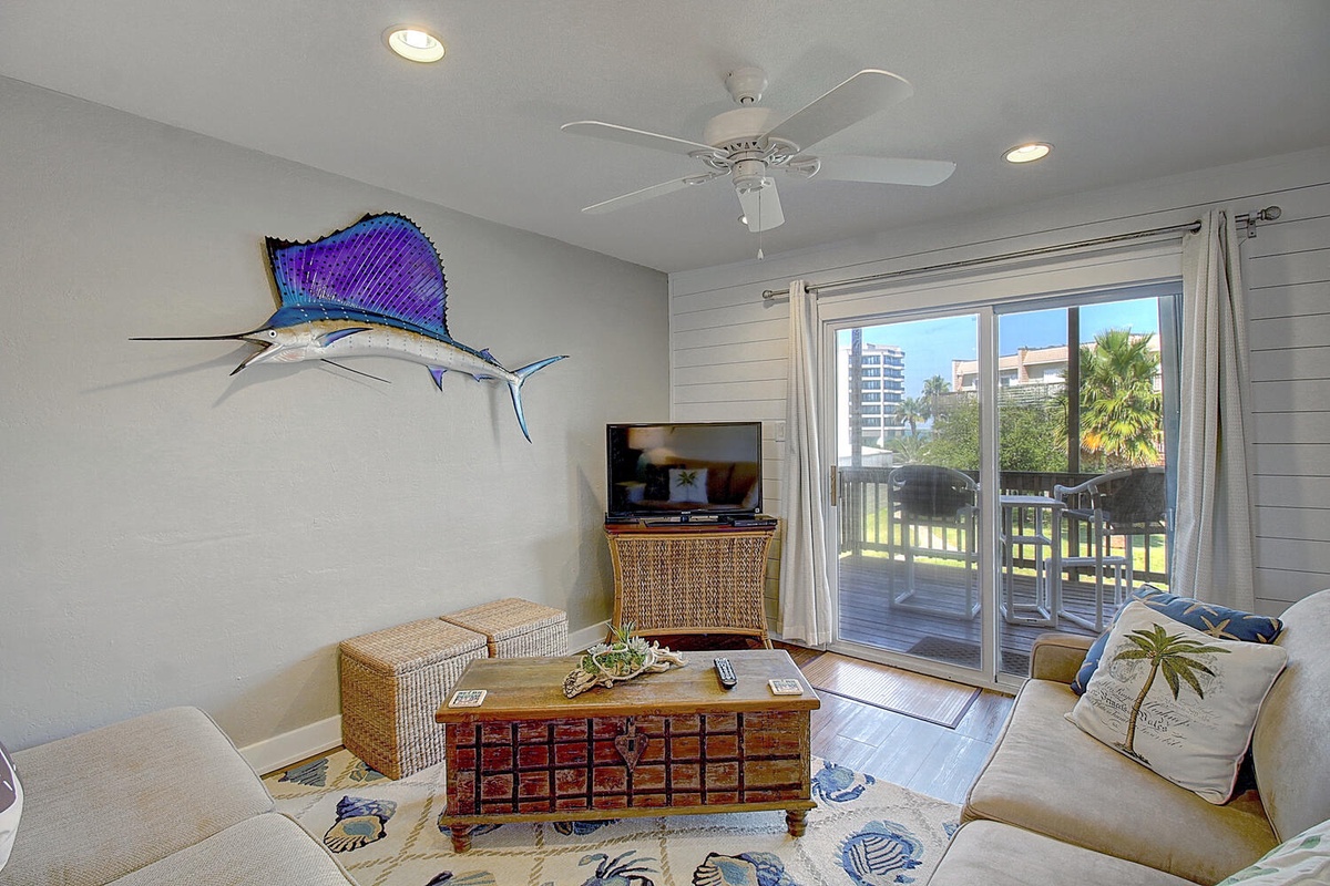 Relax in your coastal-themed living space with comfortable seating, entertainment, and your own private balcony overlooking the peaceful surroundings.