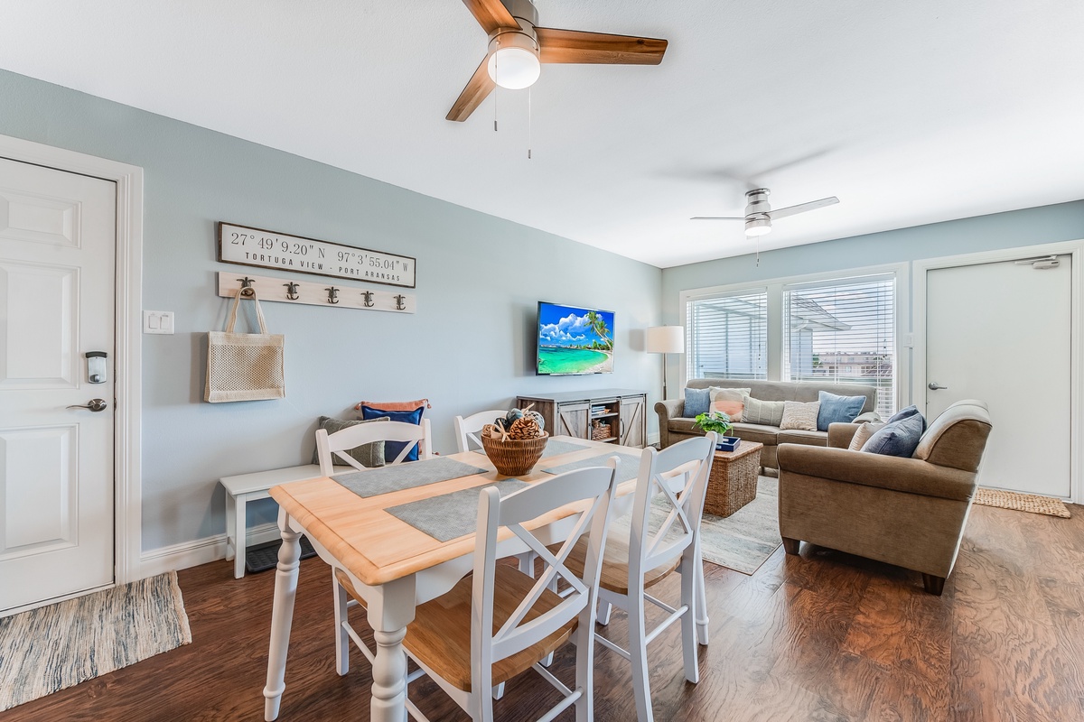 Your coastal-inspired living space blends comfort and style, with soft blue walls, natural wood floors, and thoughtful touches creating the perfect retreat for relaxation.