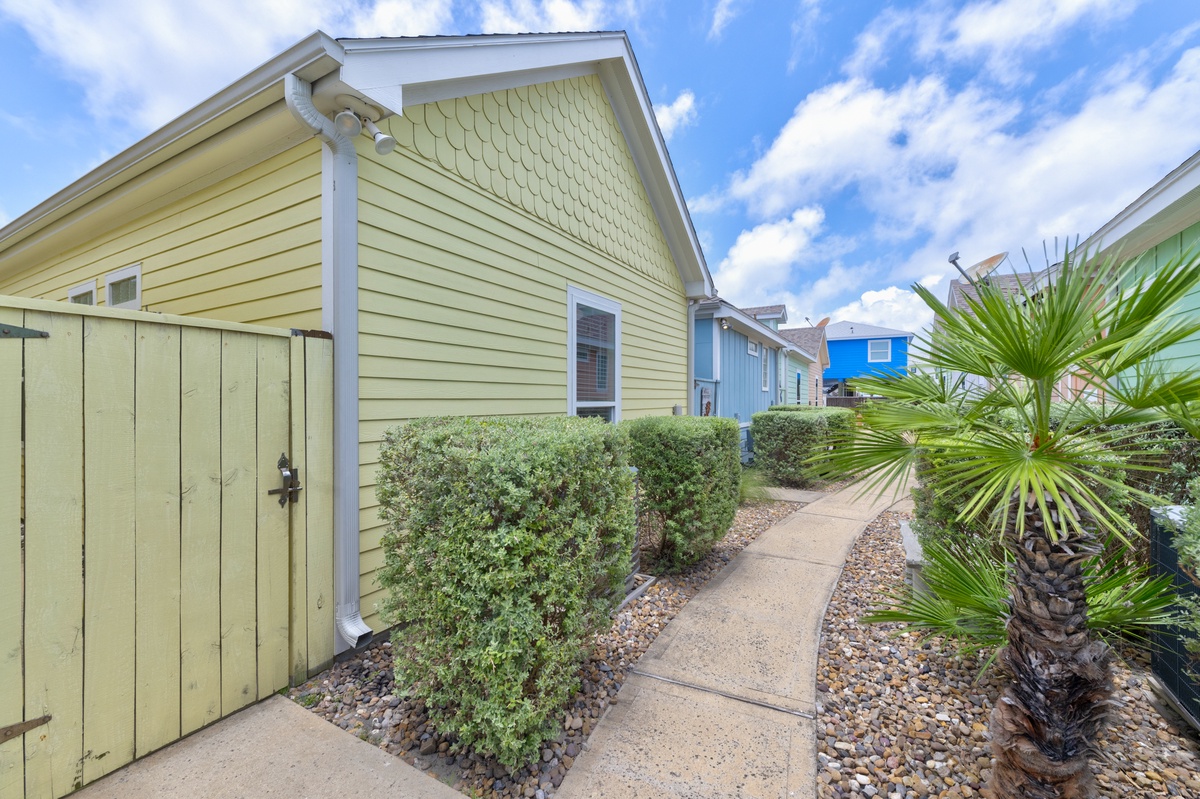 Colorful beach cottage community with tropical landscaping and charming coastal architecture.