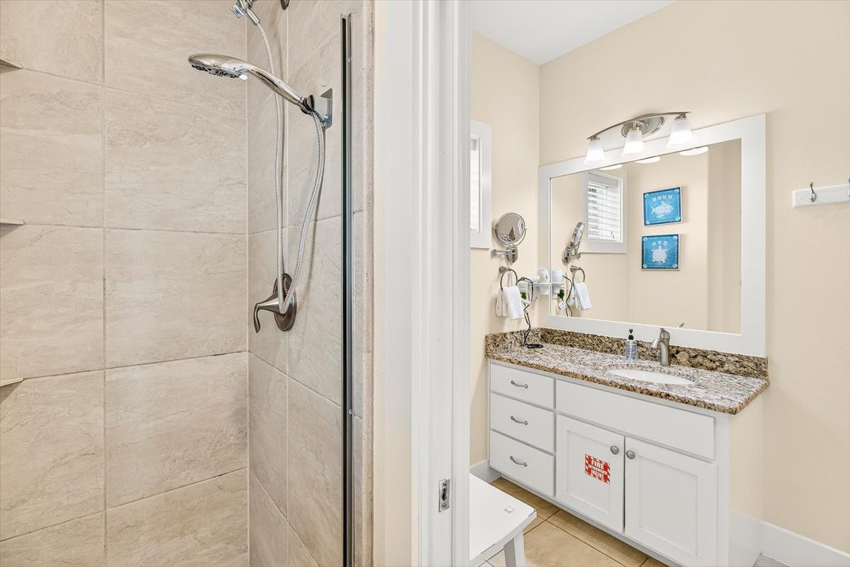 Your private bathroom offers a spacious walk-in shower with rainfall showerhead and granite vanity with ample storage for all your essentials.