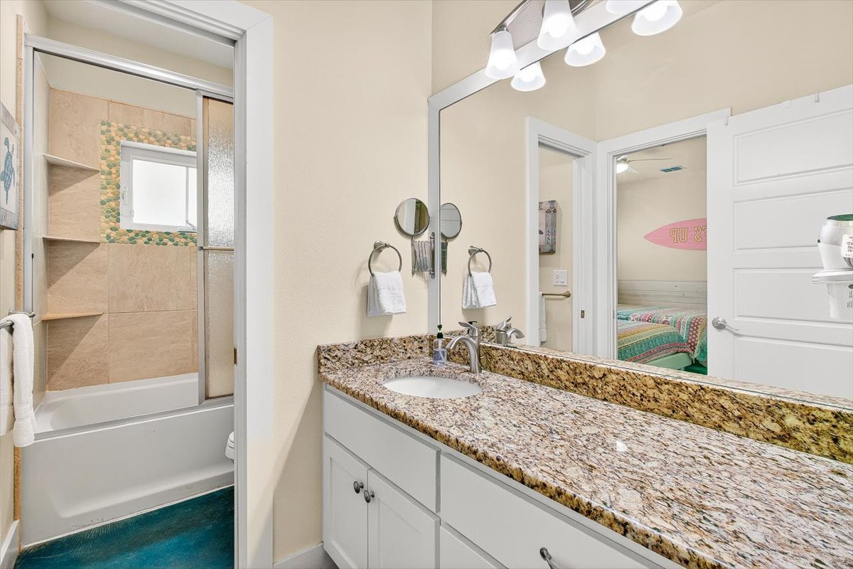 Your private bathroom features gleaming granite countertops, elegant fixtures, and bright vanity lighting for your morning routine.