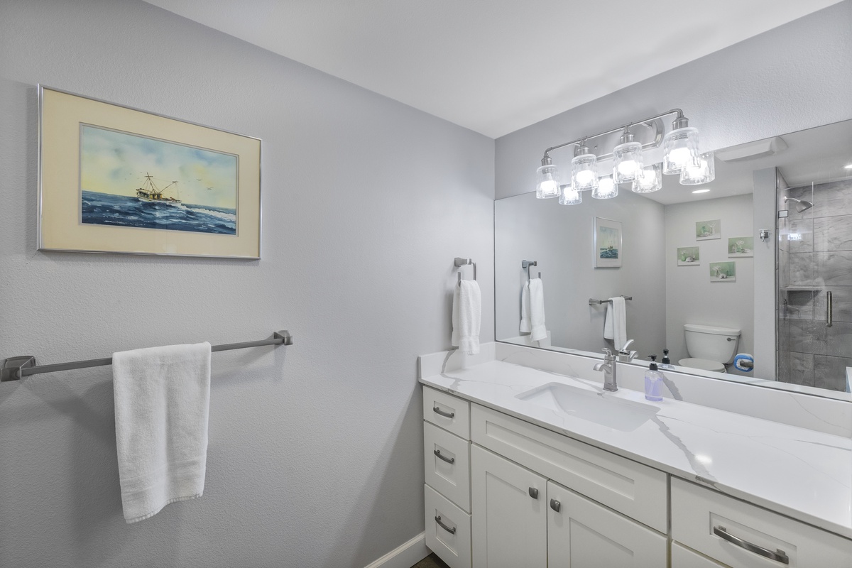 Unwind in your spa-like bathroom with a soaking tub, elegant vanity, and modern shower—perfect for relaxing after exploring.