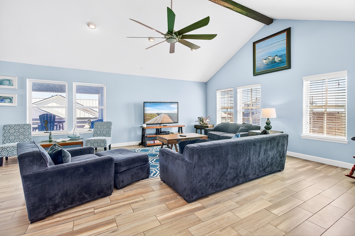 Relax in this bright, airy living room with plush seating, vaulted ceilings, and coastal charm perfect for unwinding after your adventures.