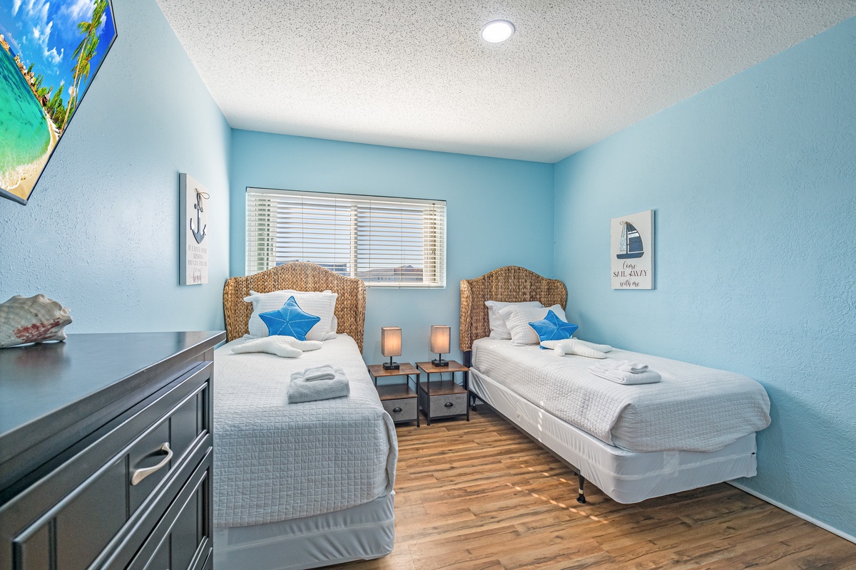Rest easy in this peaceful twin bedroom with nautical touches and crisp linens waiting for your arrival.