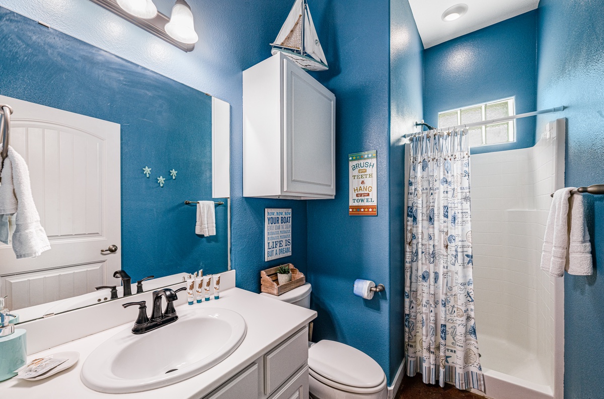 Refresh in this charming nautical bathroom with ocean-blue walls and coastal decor that makes your morning routine feel like a seaside escape.