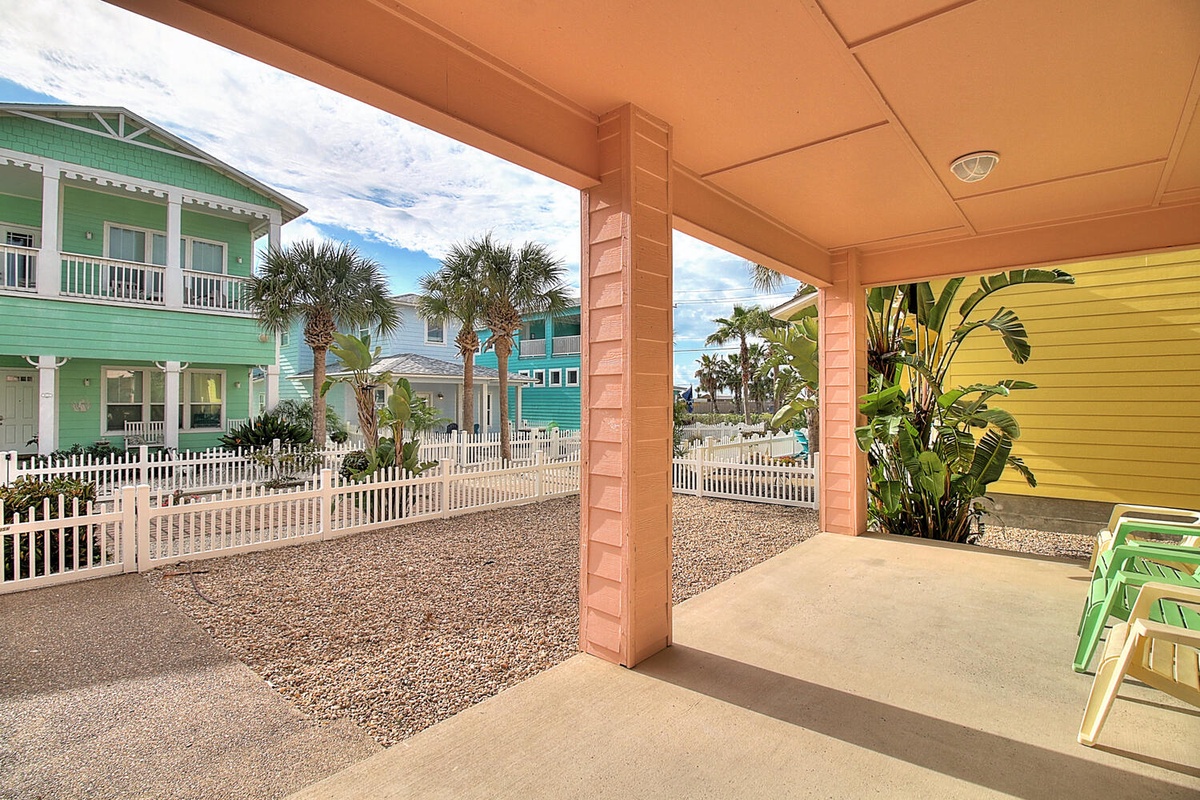 Relax on your covered patio with views of tropical palms and colorful beach houses in this charming coastal community.