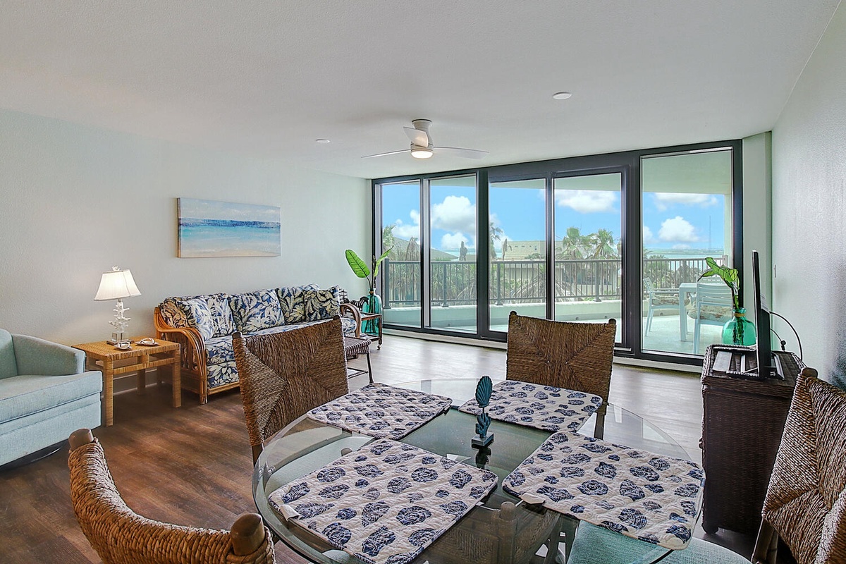 Relax in your bright living space with stunning floor-to-ceiling windows and private balcony overlooking tropical scenery.