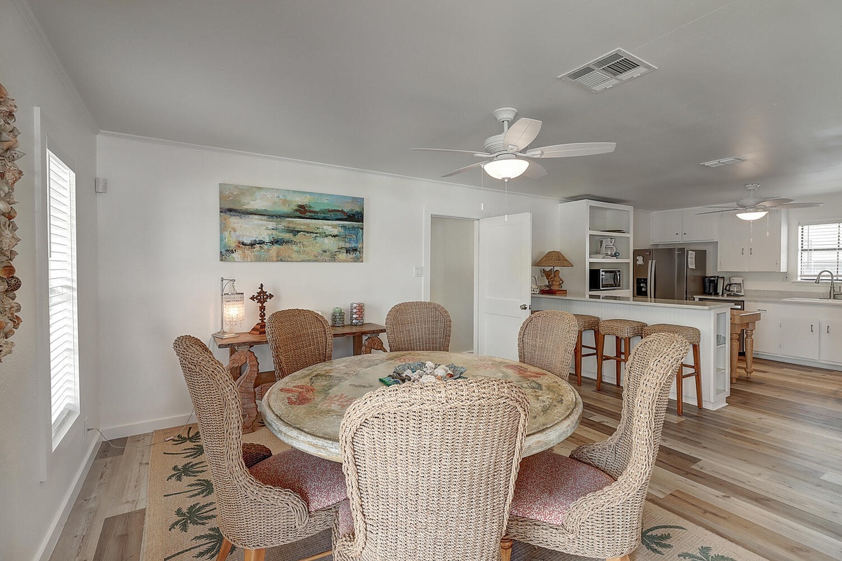 Gather around this charming coastal-themed dining space where wicker chairs invite leisurely meals with loved ones.