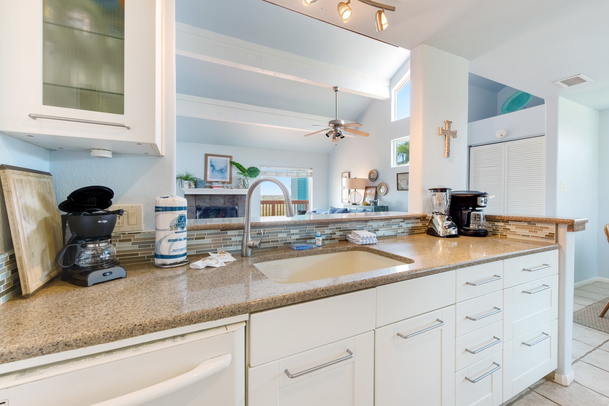 Your bright, fully-equipped kitchen invites you to prepare meals with granite counters, quality appliances, and ocean-view windows.